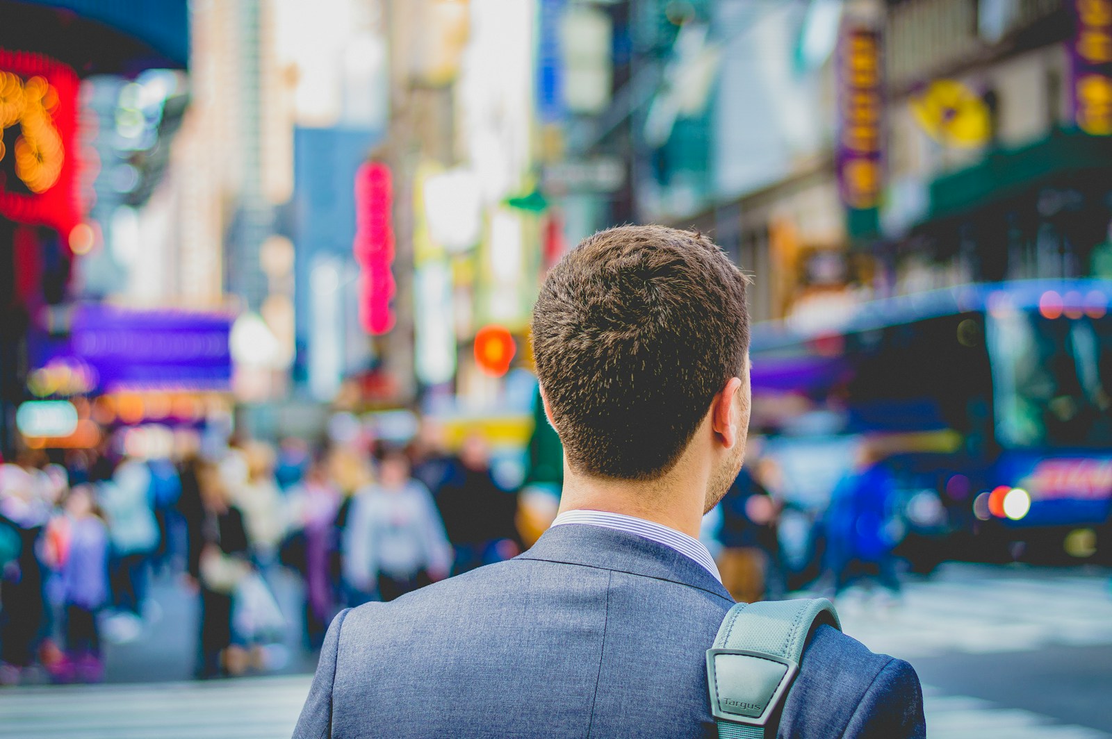 shallow focus photography of man in suit jacket's back